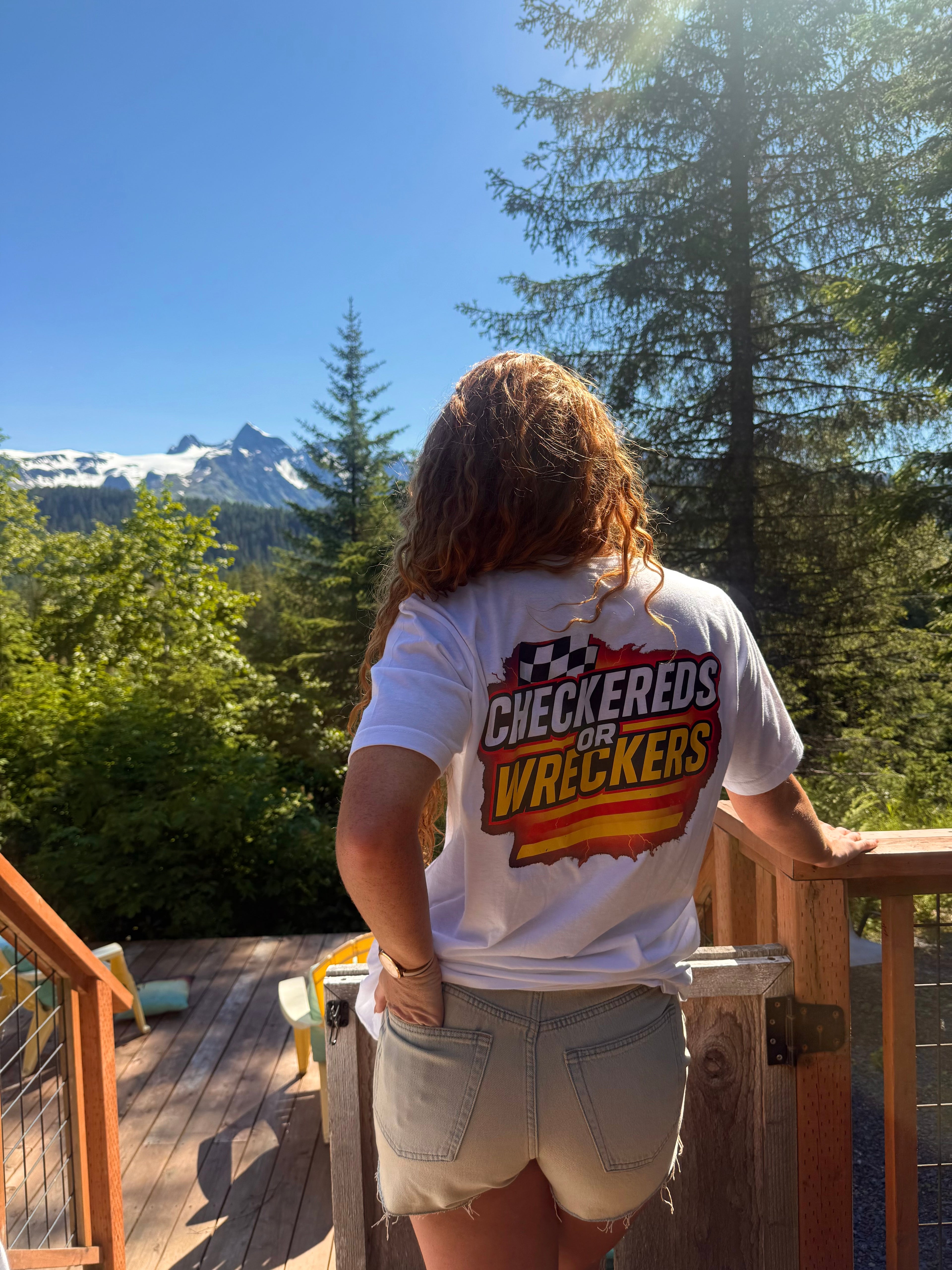 Checkereds or Wreckers black tee lifestyle shot on gravel road with dog