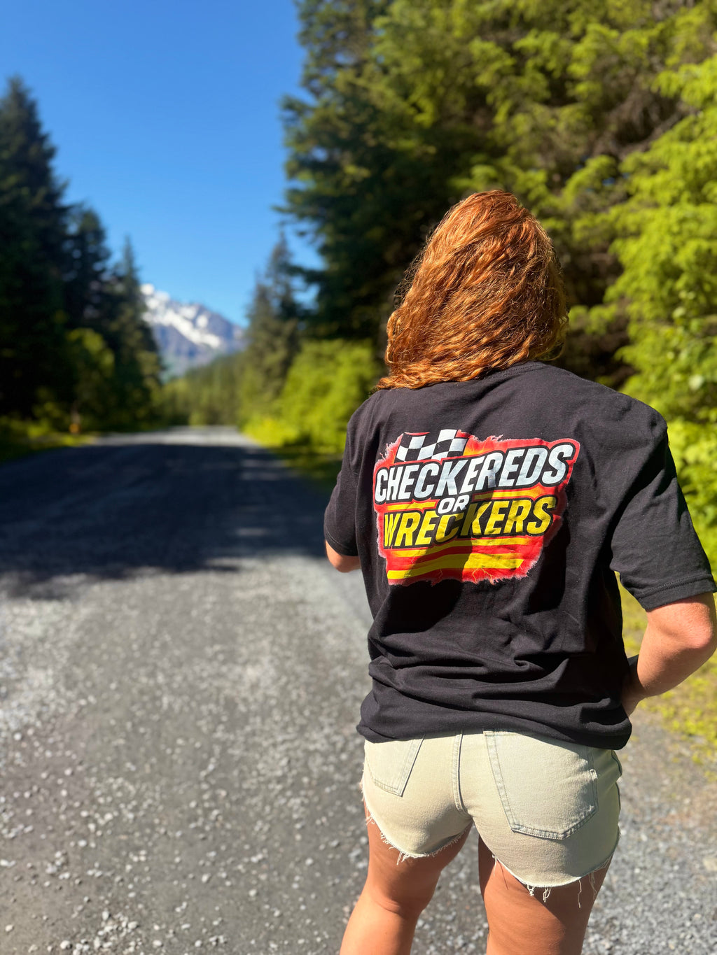 Checkereds or Wreckers black tee running on gravel road