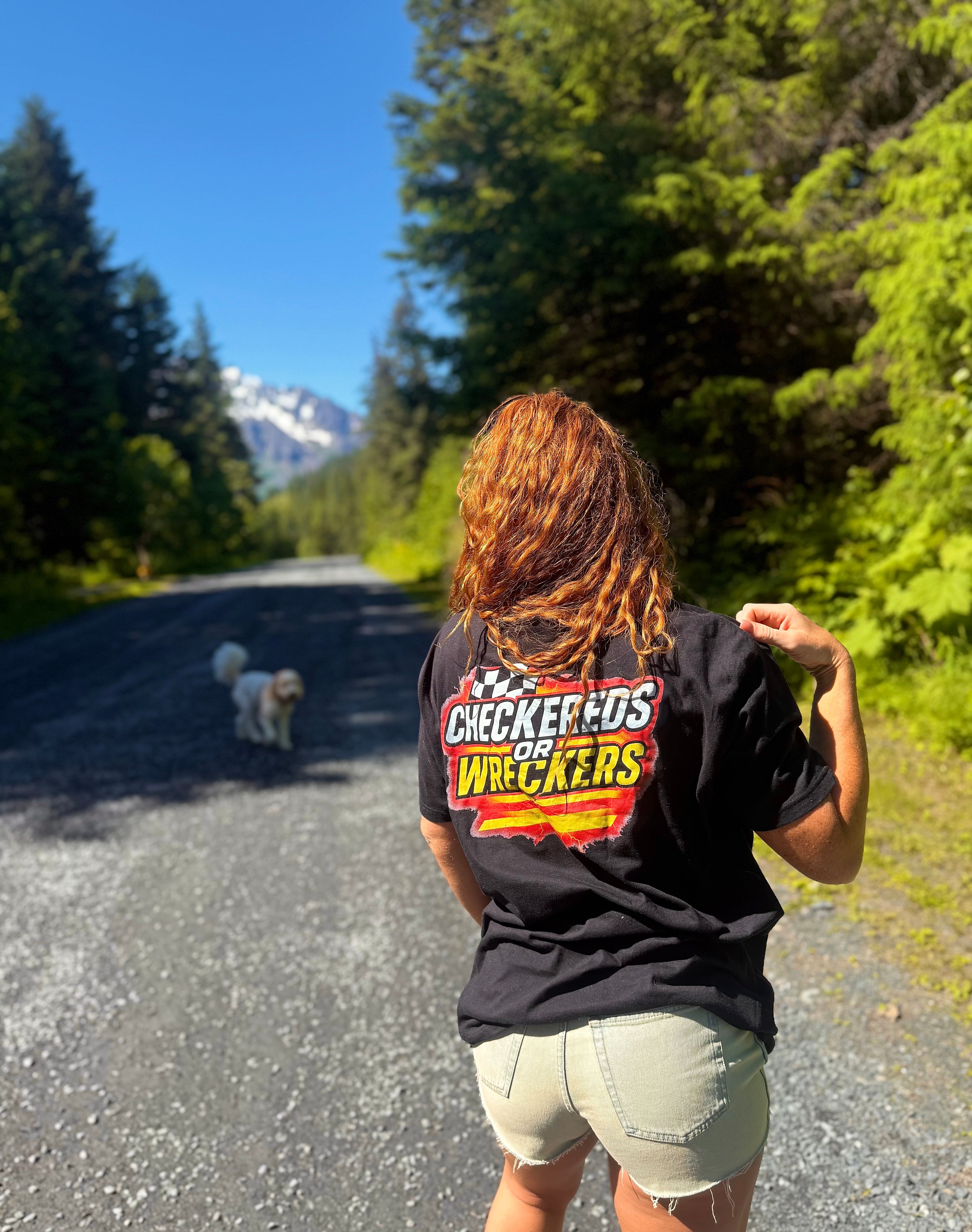 Checkereds or Wreckers black tee lifestyle shot on road with trees