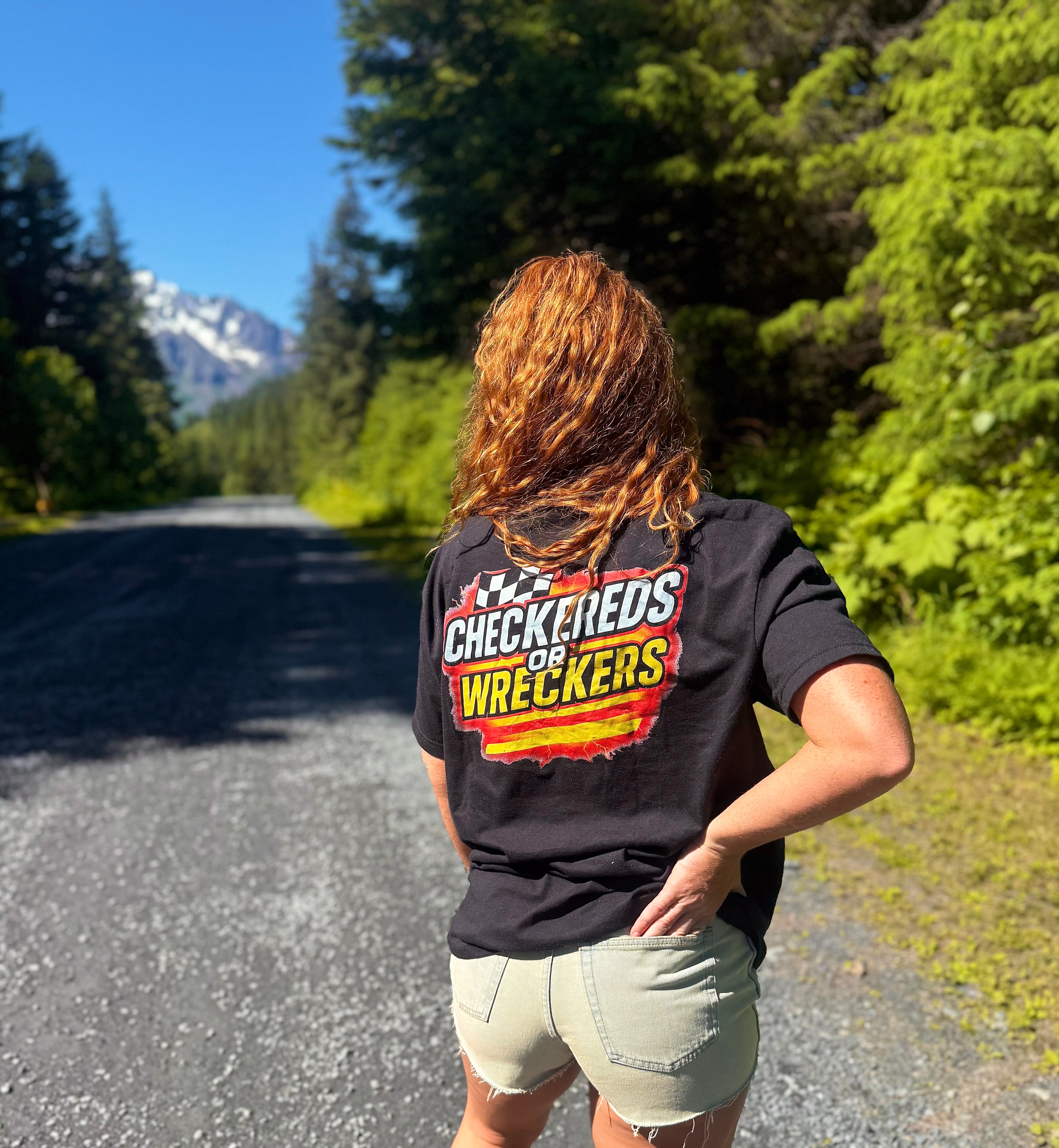 Checkereds or Wreckers white tee lifestyle shot on deck overlooking mountains